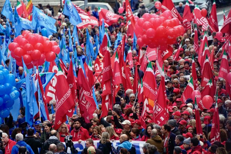 Thousands of workers march across Italy in general strike demanding better pay and services